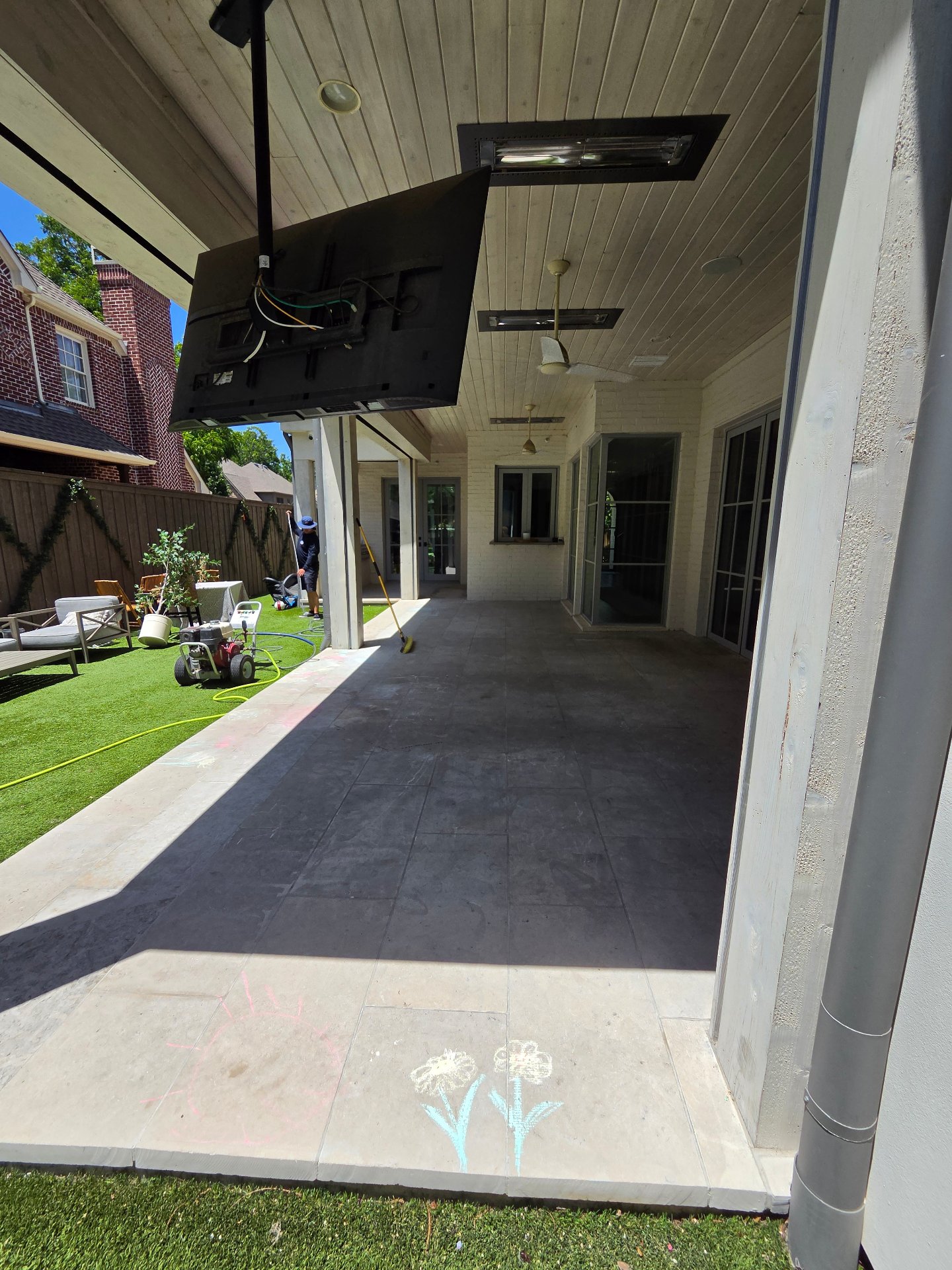 Sparkle Squad pressure-washing equipment and technician at a Dallas patio